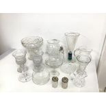 An assortment of glass and crystal including vases, a water pitcher, a sugar castor, a tazza,