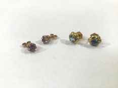 A pair of 9ct gold claw set amethyst stud earrings, and a pair of yellow metal blue stone set