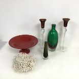 A pair of glass long stem candlesticks, one with chip to rim, a polychrome flask style vase, a bud