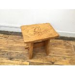 A rustic stool, the rectangular top with owl decoration, with undulating side, on splay supports