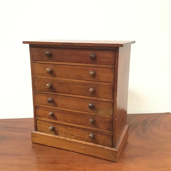 A 19thc stained pine collector's table cabinet, the rectangular top above six drawers, with