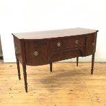 A Regency mahogany and ebony lined sideboard of small proportions, the bow front top above a pair of