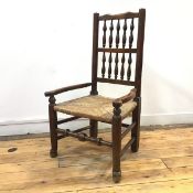 A 19thc. Lancashire armchair of small proportions, the yoke shaped top rail above two rows of turned