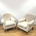 A pair of modern armchairs, in striped oatmeal upholstery, the slightly arched back over scroll