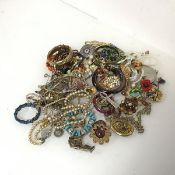 A large assortment of costume jewellery including paste and glass necklaces, brooches, pendants,