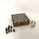 A travelling chess and backgammon set, the hinged lid with inset marble chessboard, opening to a