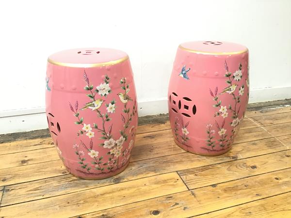 A pair of ceramic garden stools with a rose pink ground and bird and foliate decoration (45cm x d.