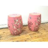 A pair of ceramic garden stools with a rose pink ground and bird and foliate decoration (45cm x d.