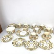 A Rockingham style teaset including eight tea cups and saucers, two additional saucers, nine side