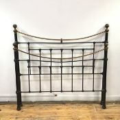 A modern black and metal and lacquered brass bedstead, with turned spar backs mounted by