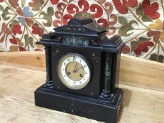 A 19thc slate mantel clock of typical form, with enamel dial with arabic numerals and trefoil