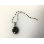 An onyx oval pendant in silver mount on a silver snake link chain (25cm) (29.43g)