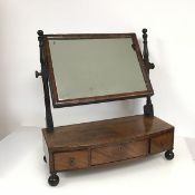 A Regency mahogany dressing table mirror, the glass held within two turned supports, on a bow