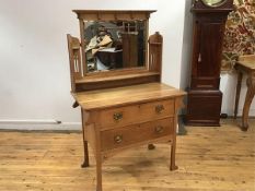 An oak Arts & Crafts dressing table, the hinged mirror with moulded cornice, on pierced gallery back