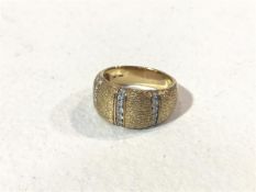 A 14ct gold hatched bombe style ring with three rows of brilliant cut diamonds (10g) (S)