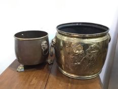 An Edwardian brass jardiniere/bucket, with lion mask handles to sides and two Gentleman in hats in