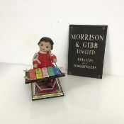 A 1950s/60s musical toy of a Young Girl playing a Xylophone, with wind up mechanism, some losses