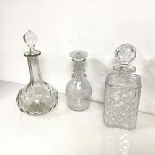 Three glass decanters of various shapes and cuts, all with stoppers (two a/f) (tallest: 28cm x d.