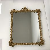 A wall mirror with C scroll and foliate decorated gilt frame (50cm x 40cm)