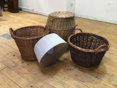 A set of three wicker baskets, two with handles to sides, the last of barrel form with lid (61cm x