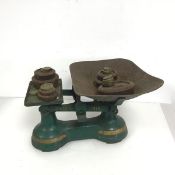 An early 20thc set of shop scales, with an assortment of weights from 5g to 4lb (23cm x 36cm x