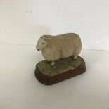 A Border Fine Arts resin figure of a Cheviot Tup, no.371/850, with stand (11cm x 13cm x 8cm)