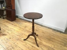 A 19thc mahogany tilt top wine table, the circular top with fluted edge on turned base and tripod