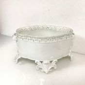 A blanc de chine jardiniere with pierced edge and handles to side, on four cartouche shaped feet (