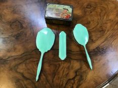 A 1930s guilloche toiletry set including mirror, hairbrush and clothes brush in mint green and an