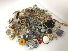 A large assortment of costume jewellery including paste and glass badges, of various forms including