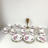 A set of ten tea cups, with pink rose and gilt decoration with twelve saucers and side plates (