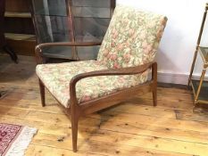 A 1960s/70s teak framed open arm easy chair, with upholstered panel back in floral tapestry, with