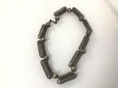 A metal necklace consisting of hollow beads and cylinders (29cm)