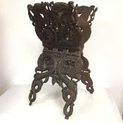 An unusual late 19thc. carved hardwood magazine/music stand, the pierced cross frame with carved