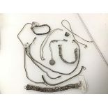 An assortment of silver, white metal and other necklaces and bracelets and a ring (11)