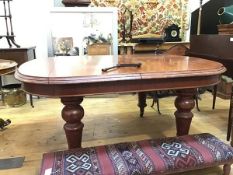 A late 19thc mahogany extending dining table, with moulded edge on turned supports ending in