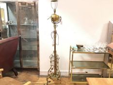 An Edwardian telescopic brass oil lamp converted to floor lamp with fluted centre column raised on