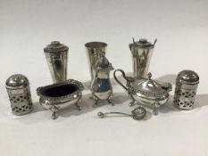 A pair of pierced Epns pepperettes, a three piece modern Birmingham silver condiment set and aset of