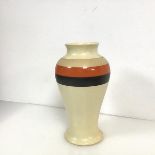 A 1930s baluster shaped vase with black, orange and tan stripes and stamped JHML within a knot to