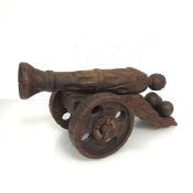 A carved pine model of a canon, first half of the 20thc., with carved barrel and carriage, with