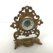 A mid 19thc gilt metal pocket watch stand, cast with rococo scrolls, later fitted with a clock (17cm