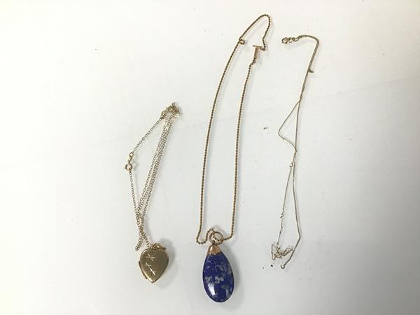 A lapis lazuli pendant on a 9ct gold chain together with a 9ct gold trace link chain and a heart