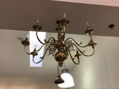 A modern brass Dutch style chandelier with eight scroll arms over pendant (48cm x 84cm)