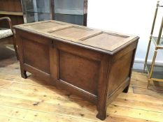 An 18thc oak triple panel coffer, the hinged top enclosing a plain interior, on square moulded