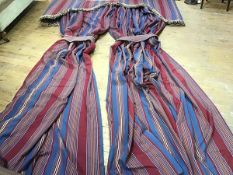 A large pair of interlined curtains in a striped fabric, shades of blue, red and yellow, with