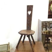 An Edwardian oak spinning chair, the tapering back with rosettes and pierced heart, with an
