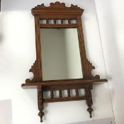 An early 20thc wall mirror with mahogany frame, with carved surmount over moulded cornice, the glass