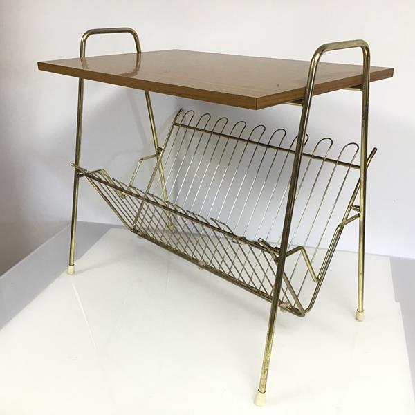 A vintage Atomic style magazine table, the rectangular top flanked by two handles, above a