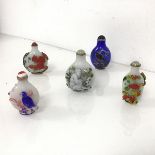 A group of Chinese snuff bottles, three depicting birds on branches, one with squirrels and a monkey