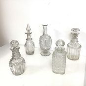 A collection of decanters of various shapes and cuts, one lacking stopper (a/f) (largest: 27cm x